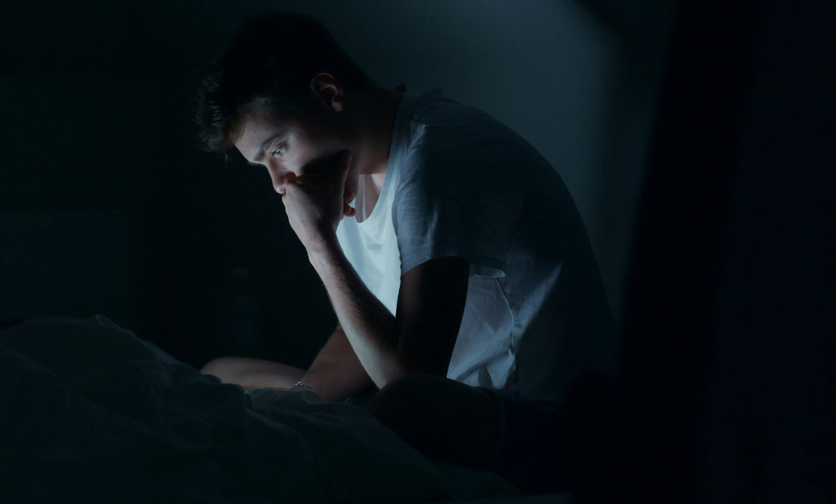man at his computer looking worried at night