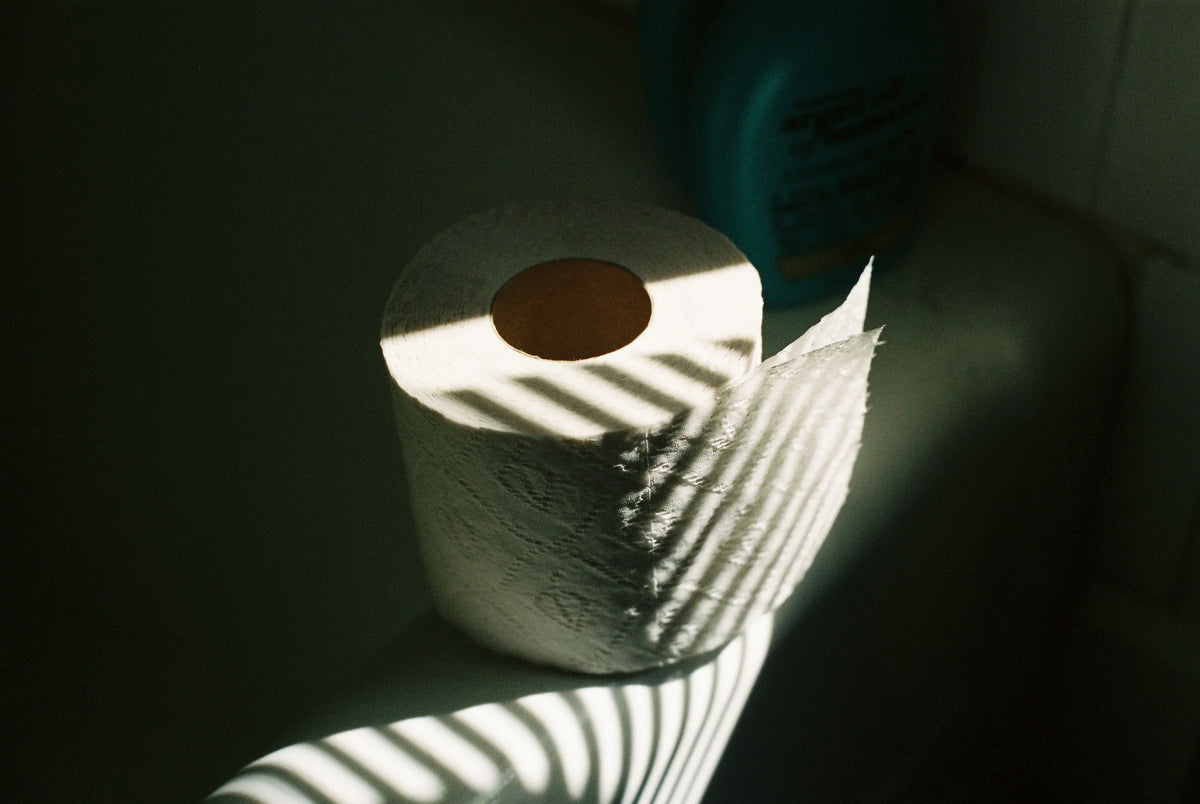 a roll of toilet paper with shadows cast over it