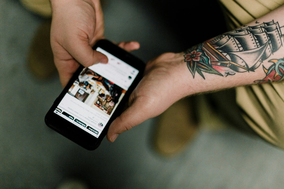 Person scrolling on a smartphone while seated