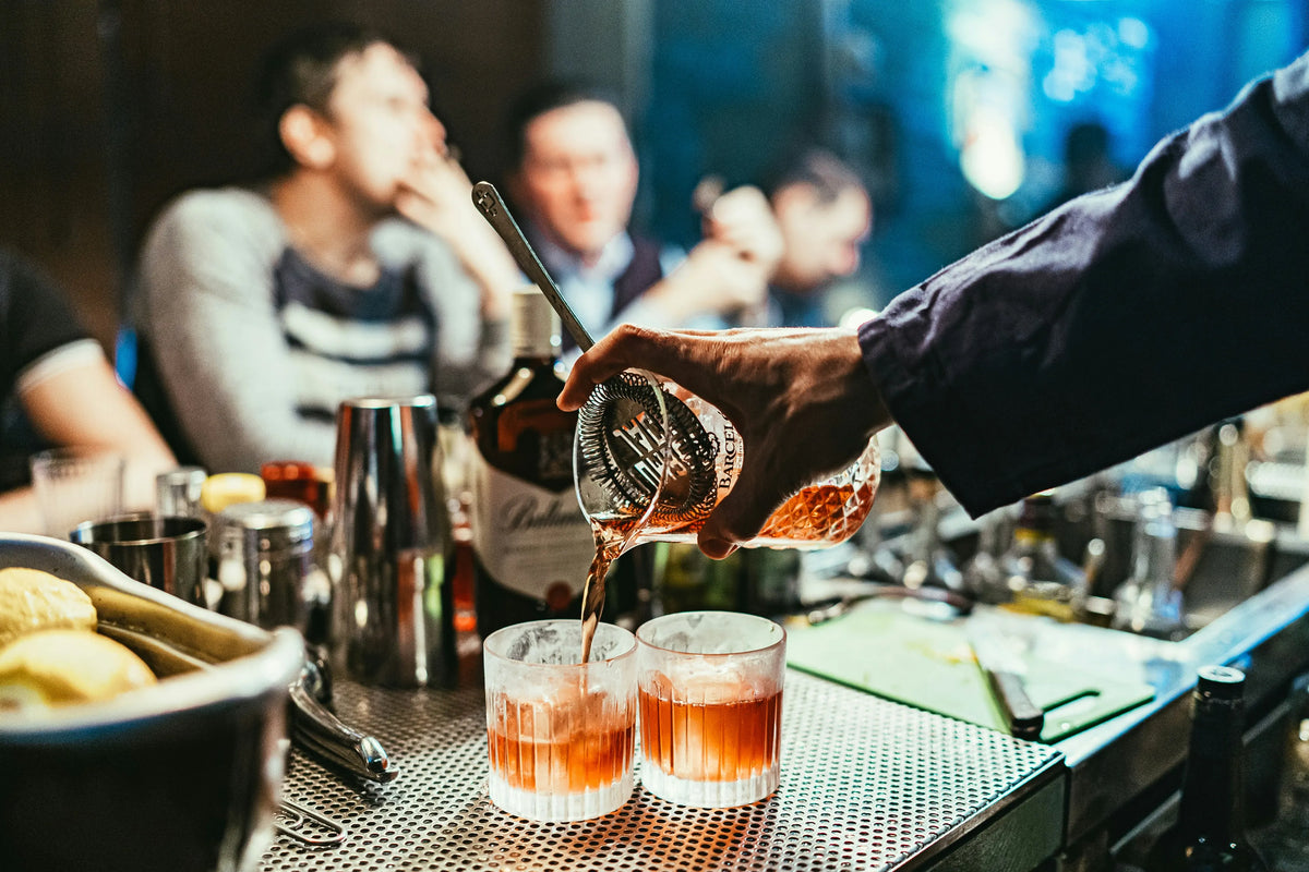friends drinking alcoholic beverages at a cocktail bar