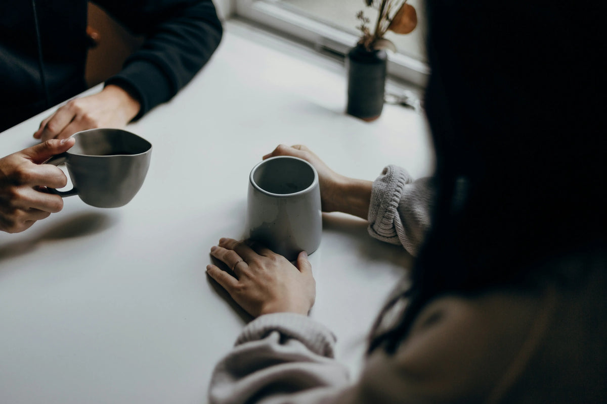 two people drinking coffee together