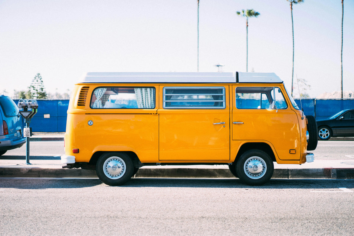 Yellow vintage van parked by the beach